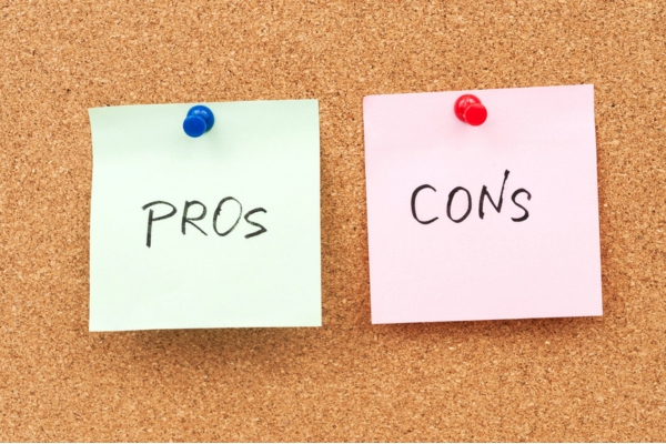 pros and cons notes pinned on corkboard