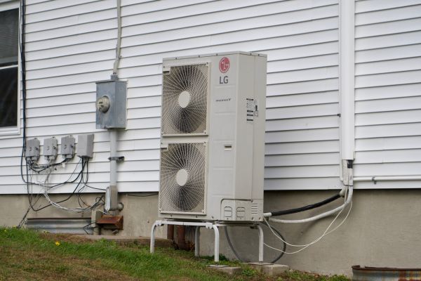 residential heat pump set-up on the side of the house