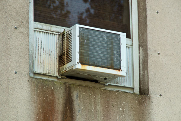 rusty old air conditioning unit depicting residential cooling