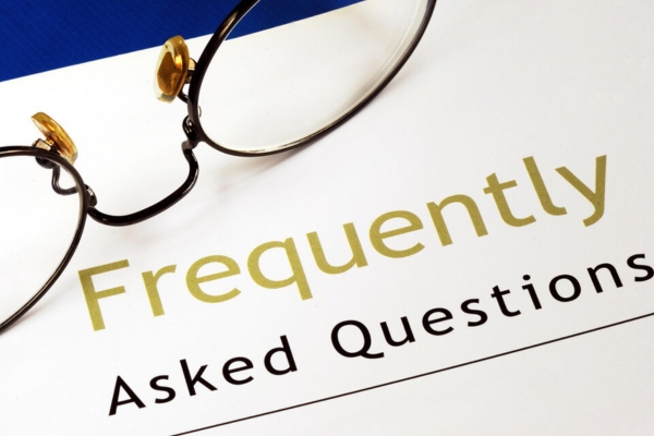 frequently asked questions printed on a bond paper with eyeglasses on top