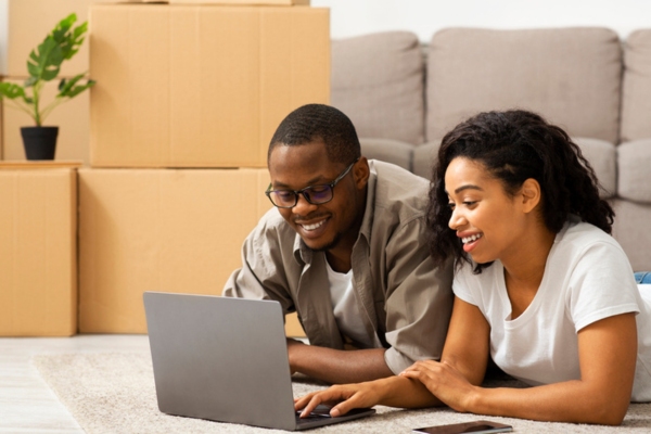 couple moving houses researching the best SEER rating for air conditioner