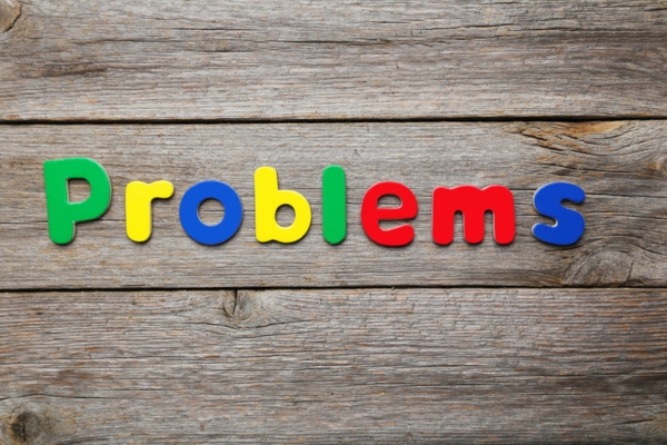 problems spelled on wooden table using colorful letters depicting Commercial Fuel Storage Tanks