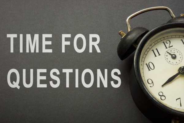 time for questions beside desk alarm clock depicting FAQs