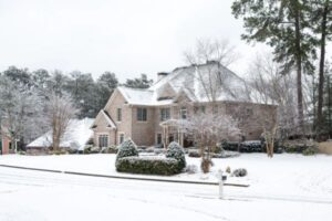 house and street covered with snow due to extremely cold weather