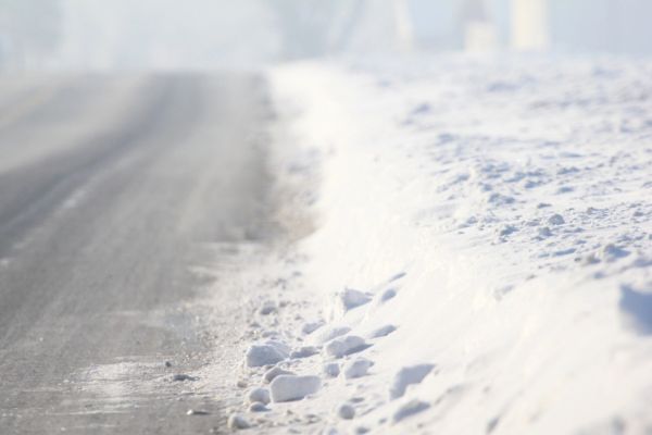 snow on the edge of the road depicting frozen heating oil