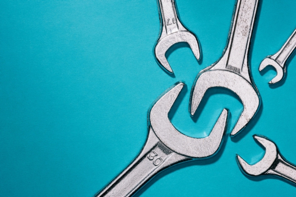 different sized wrenches in blue background depicting heating system repair