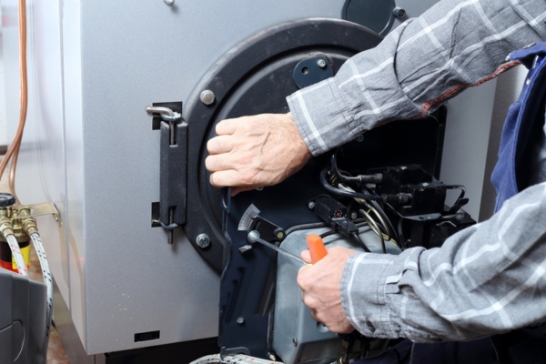 professional technician attending to an oil burner